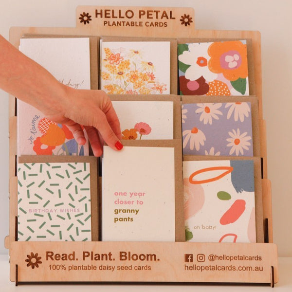Box of Hello Petal plantable cards with a hand reaching for one card.